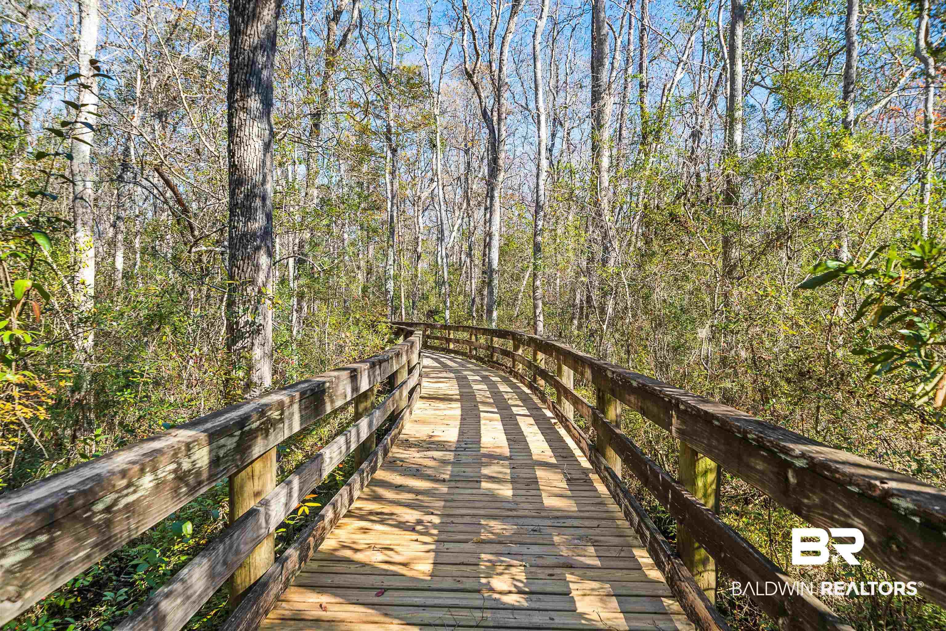 Image 3: View of property's community with a wooded view