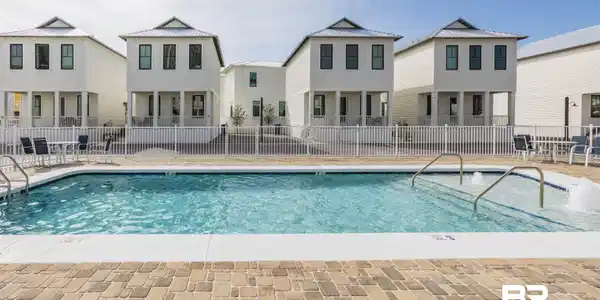 Image 3: Community pool featuring a residential view and a patio area