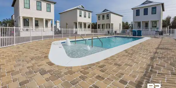 Image 4: Community pool with a patio