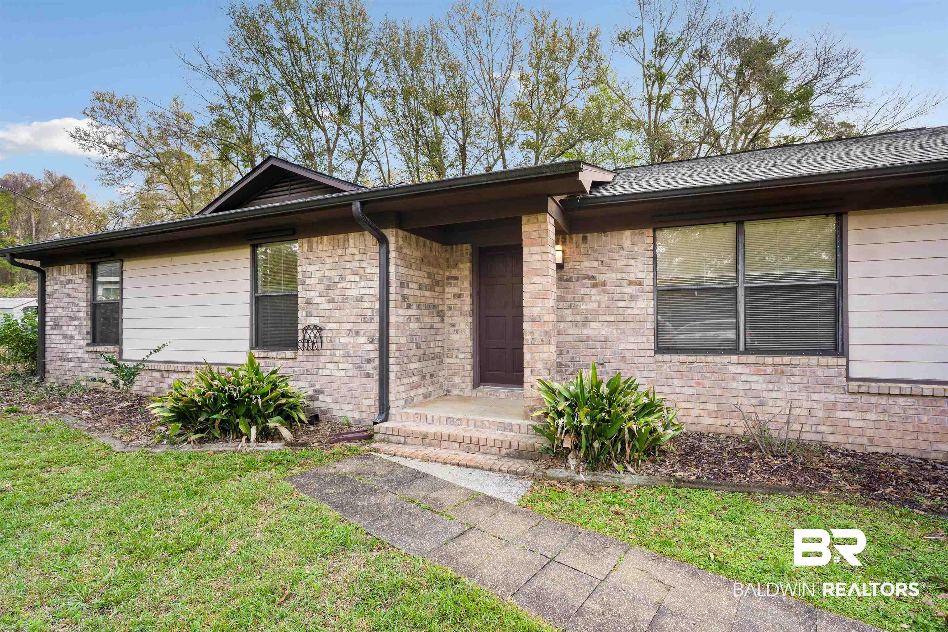 Image 4: Ranch-style home featuring a front yard and brick siding