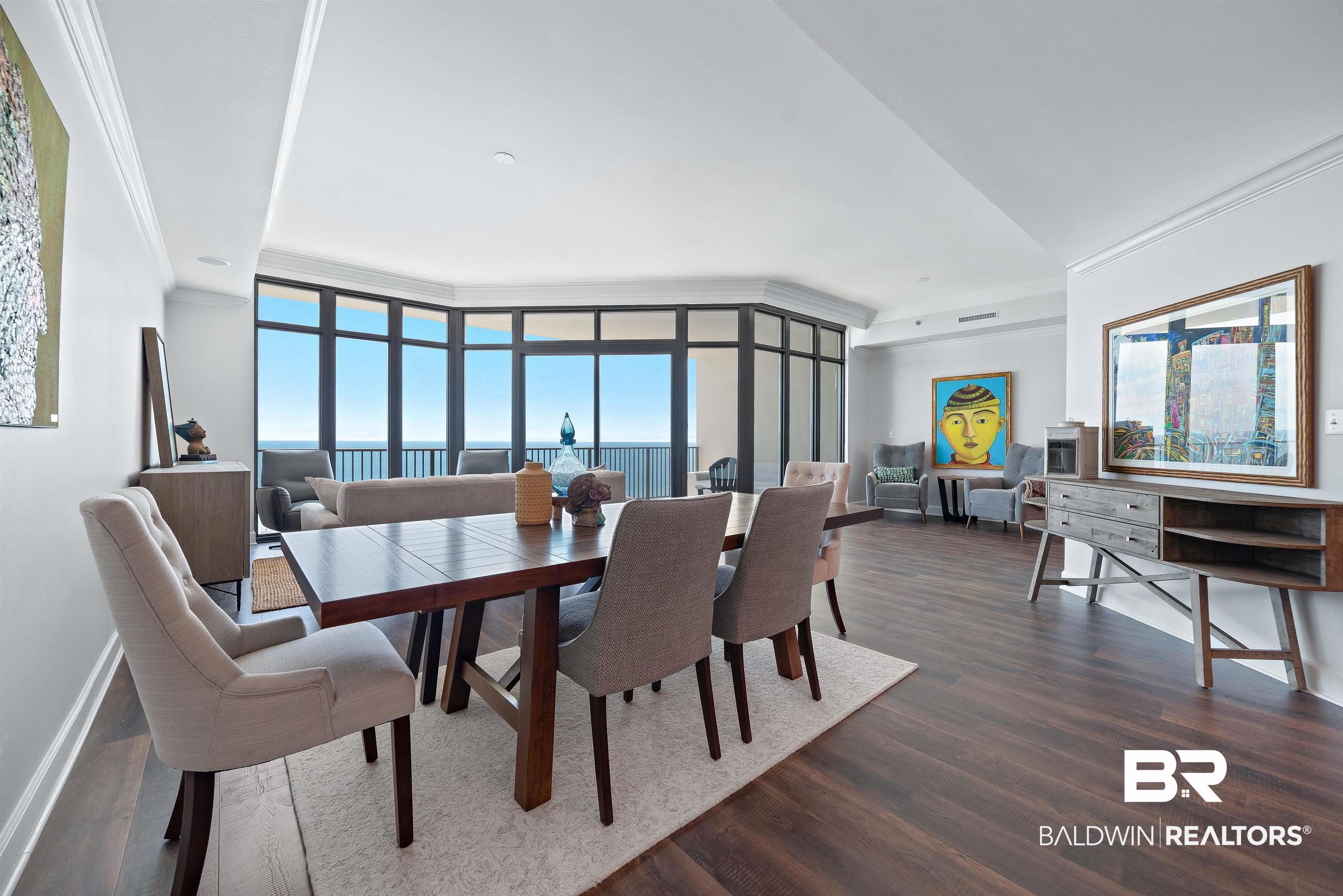 Image 2: Dining room featuring crown molding, dark wood finished floors, and expansive windows