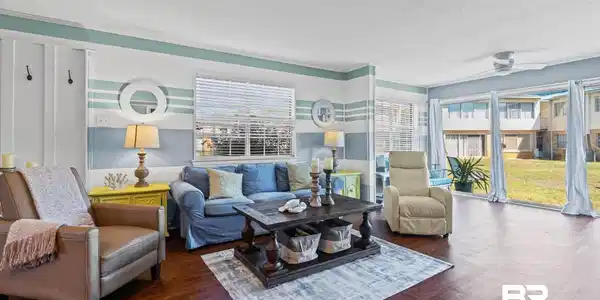 Image 4: Living area featuring wood-finish flooring, a ceiling fan, and sliding glass doors