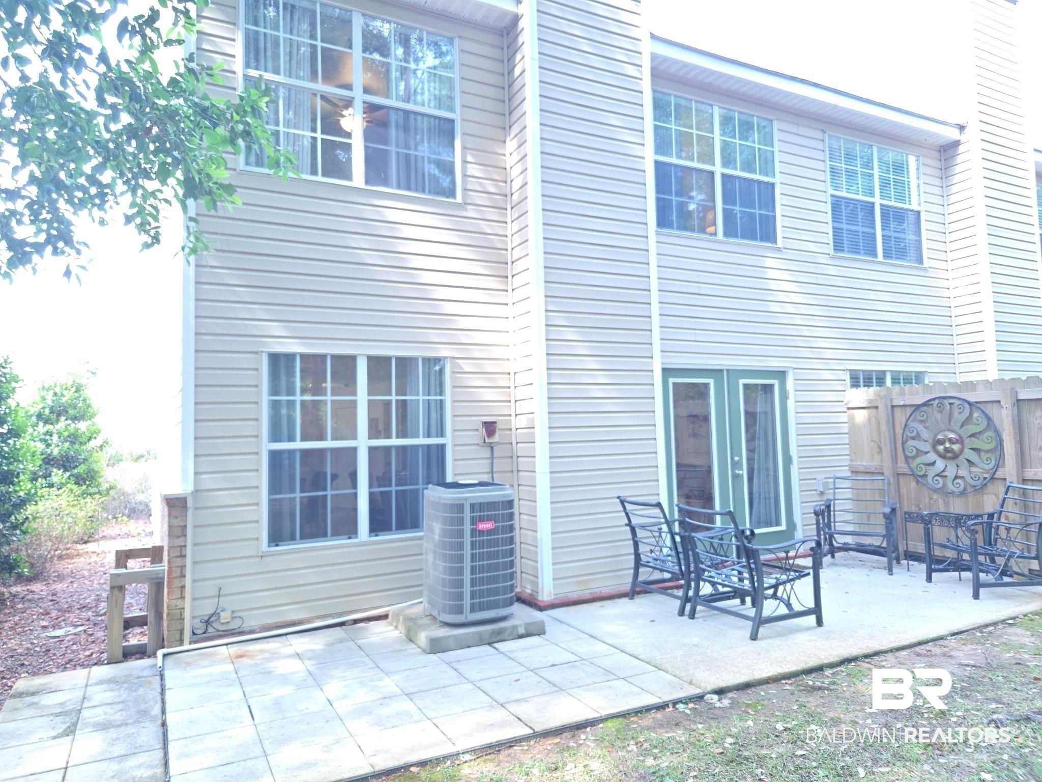 Image 3: Rear exterior featuring tan horizontal siding