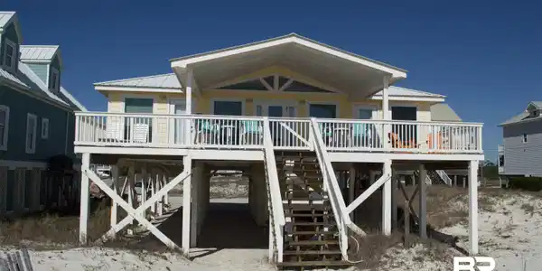 Image 2: Back of property with a metal roof and a wooden deck
