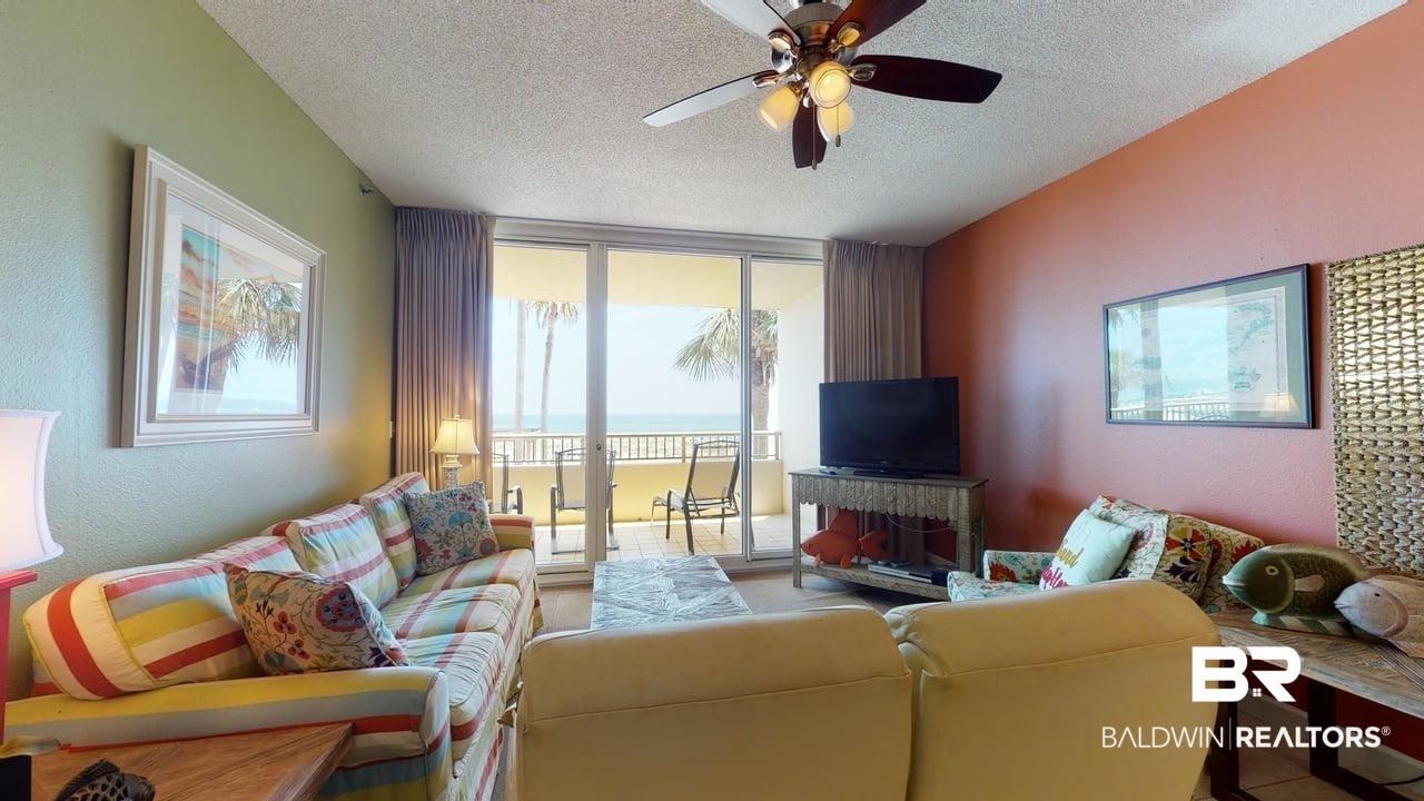 Image 3: Living room featuring a textured ceiling, expansive windows, ceiling fan, and a textured wall