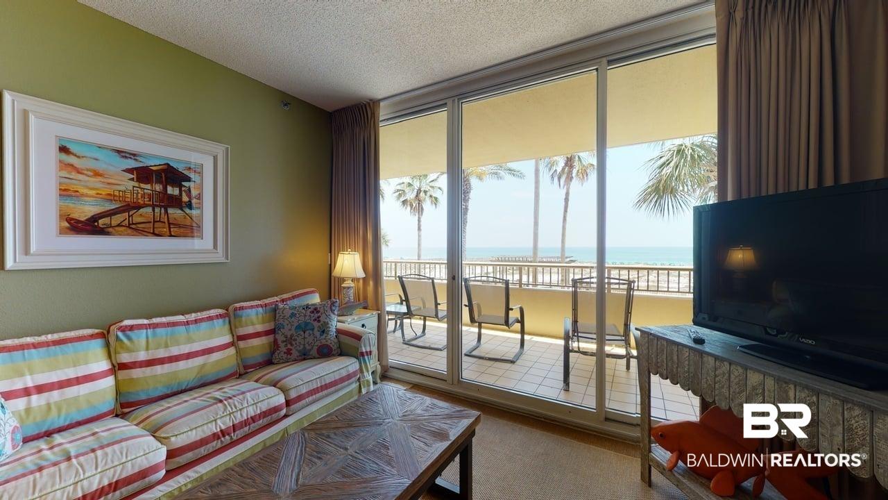 Image 4: Living area featuring a textured ceiling and carpet flooring
