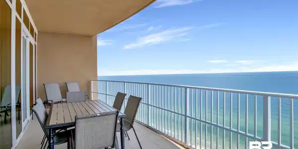 Image 2: Expansive outdoor balcony featuring a white railing, tile flooring, and a broad ocean backdrop