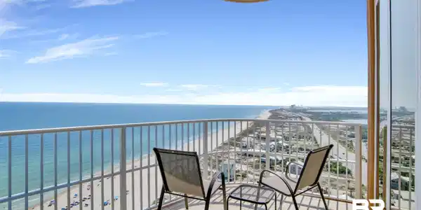 Image 3: Expansive balcony featuring a white railing, a beige curved ceiling, and light-colored tile flooring