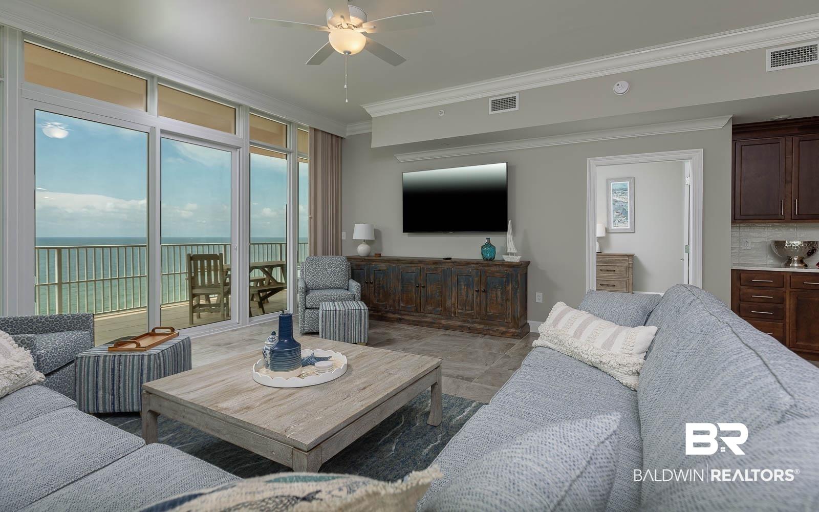 Image 3: Living room with ceiling fan and crown molding