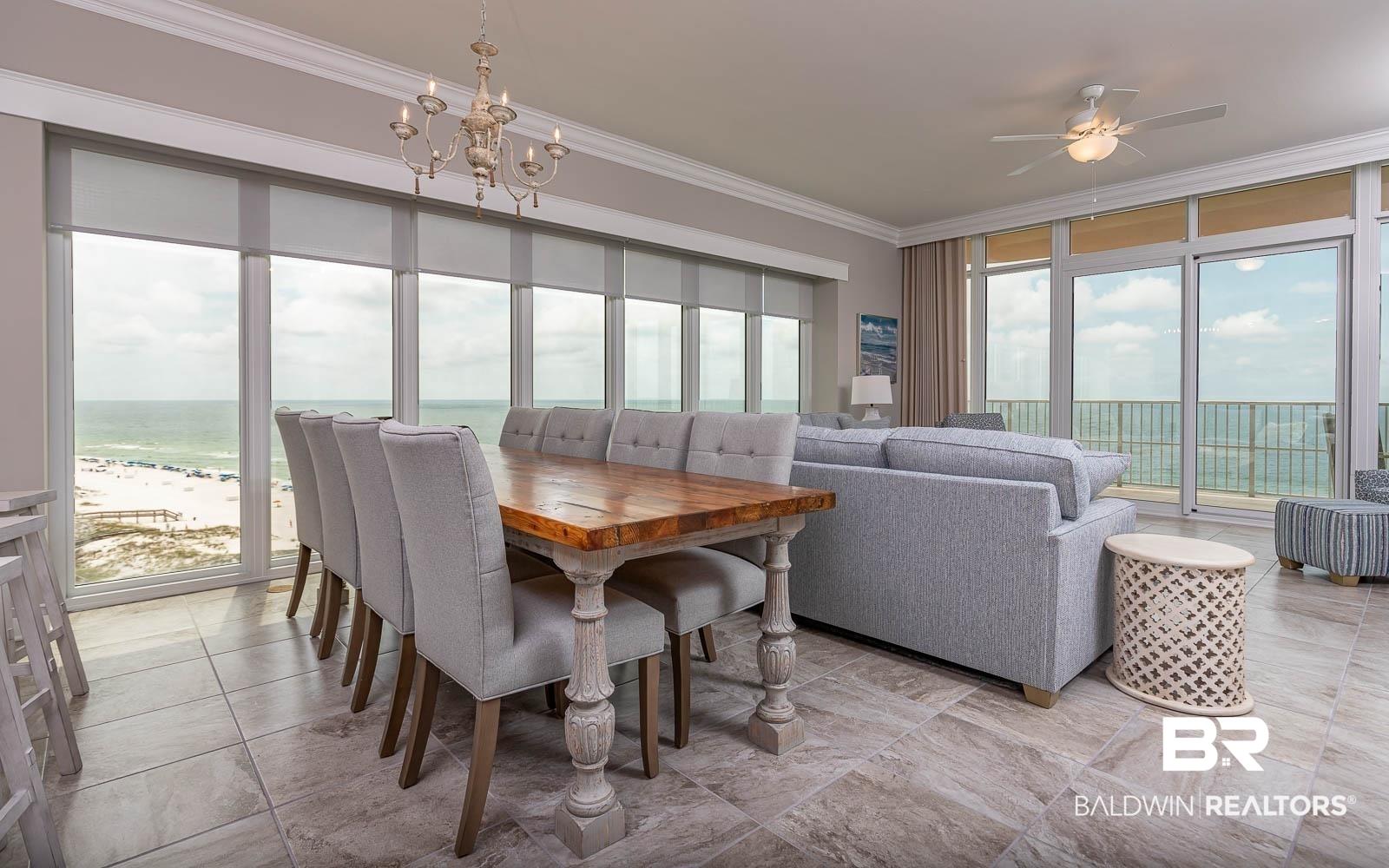 Image 4: Dining room with ceiling fan with notable chandelier, a water view, and crown molding
