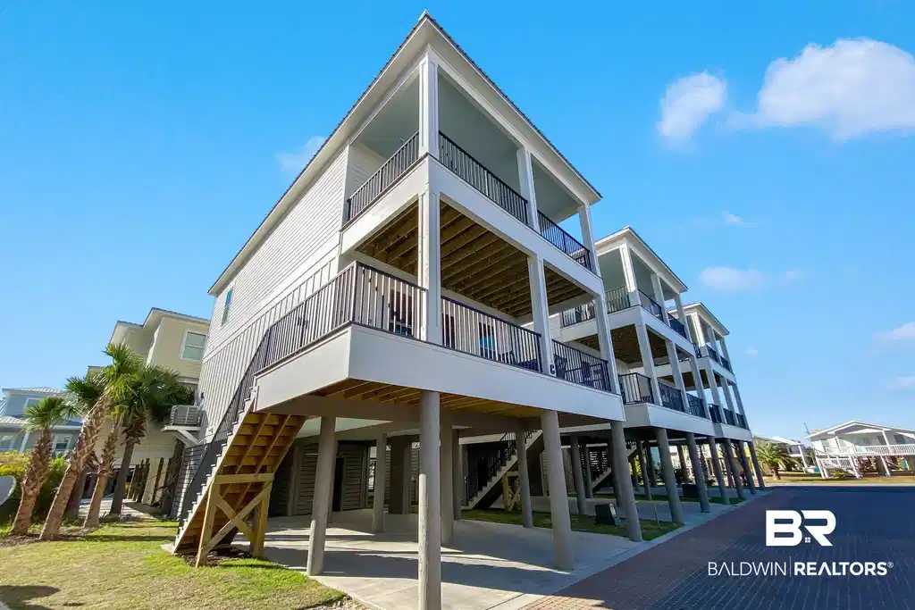 Image 1: View of building exterior with a carport