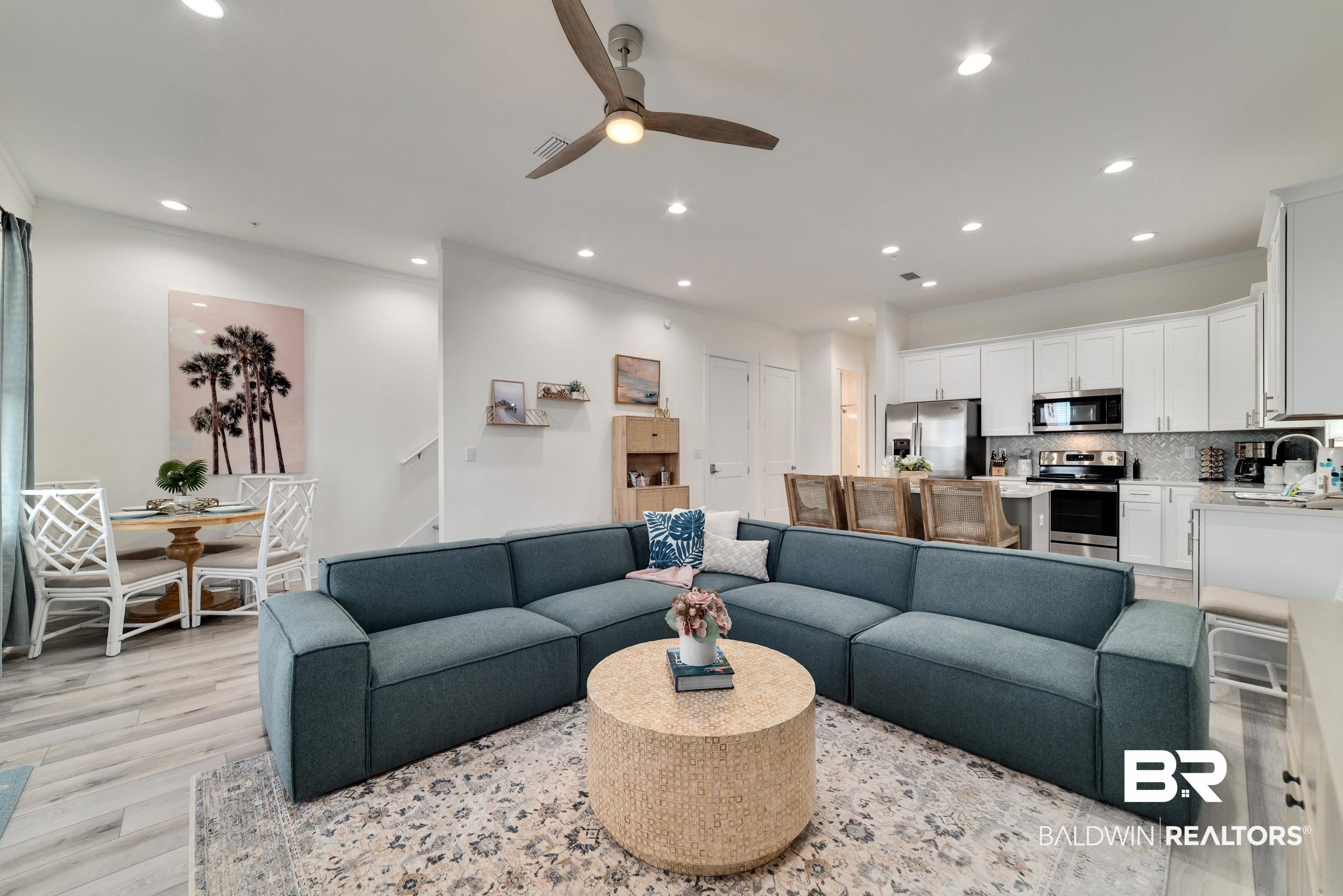 Image 4: Living room with a ceiling fan, light wood-style floors, and recessed lighting