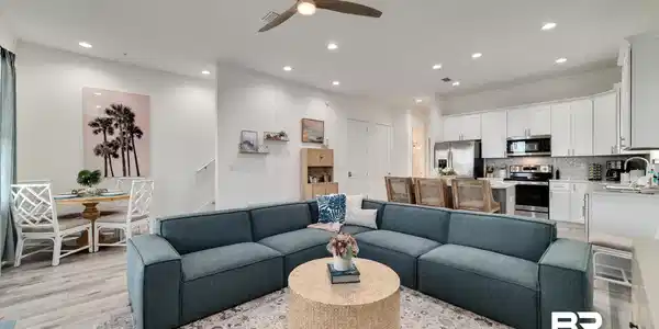 Image 4: Living room with a ceiling fan, light wood-style floors, and recessed lighting