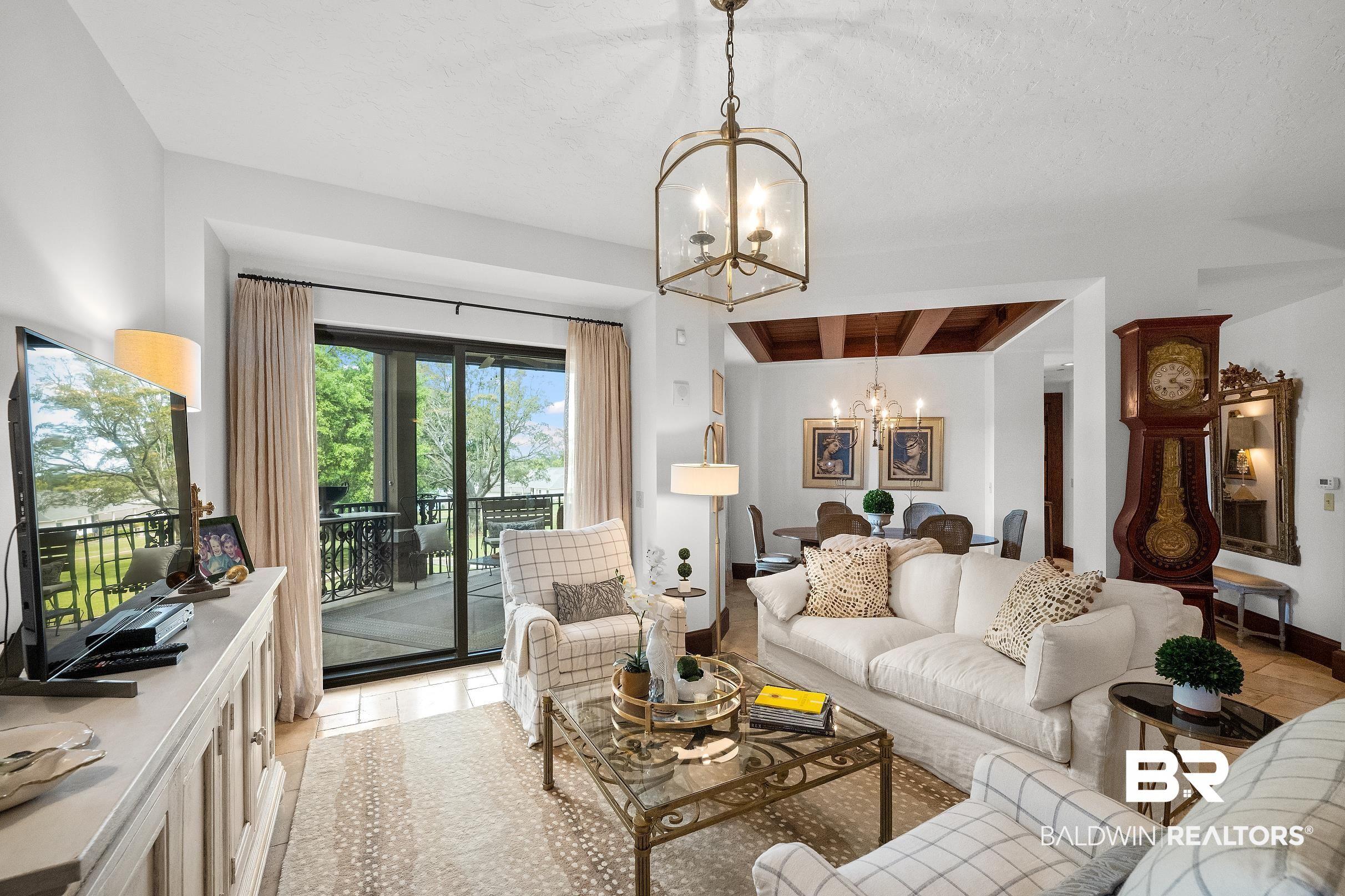 Image 3: Living room with hanging lights and beam ceiling