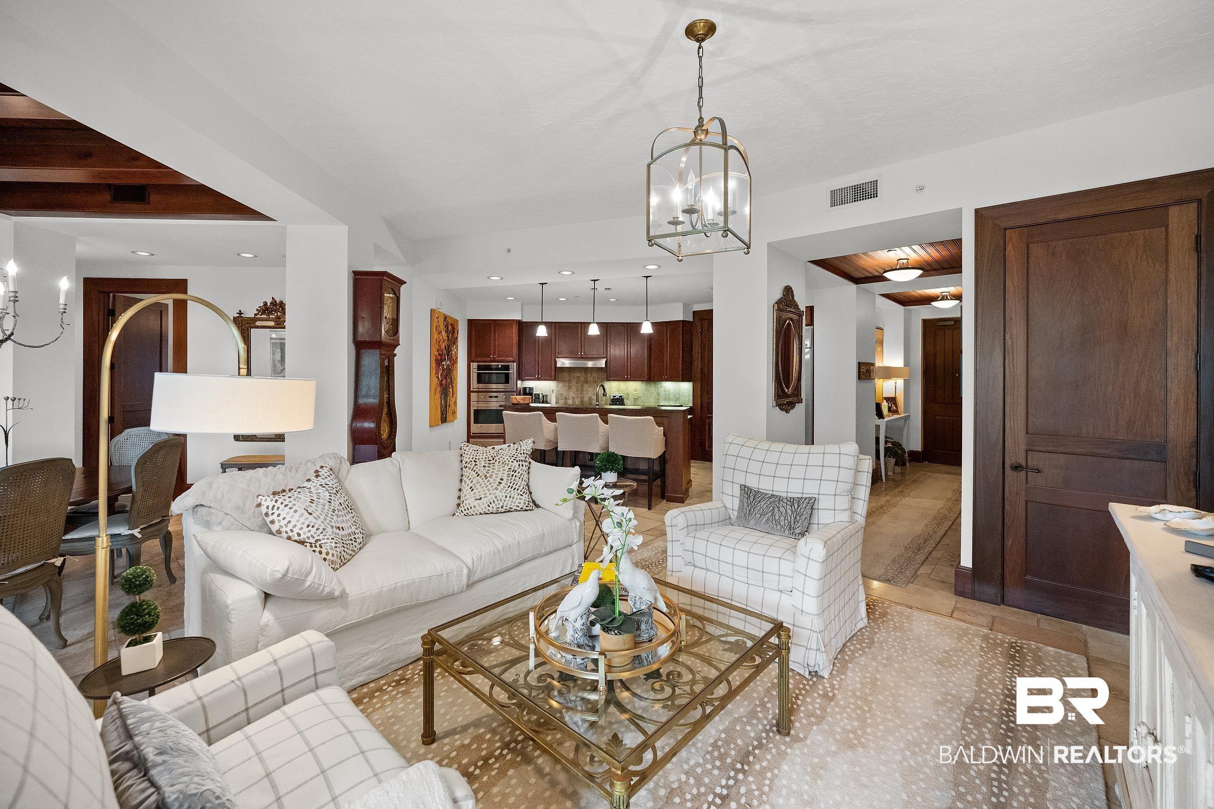 Image 4: Living area with hanging lights and stone tile flooring