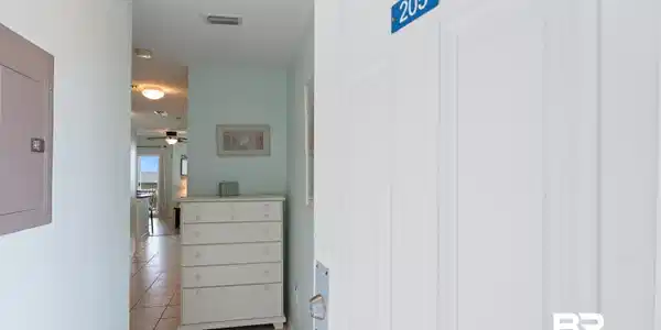 Image 2: Entryway featuring light-colored walls and tiled flooring