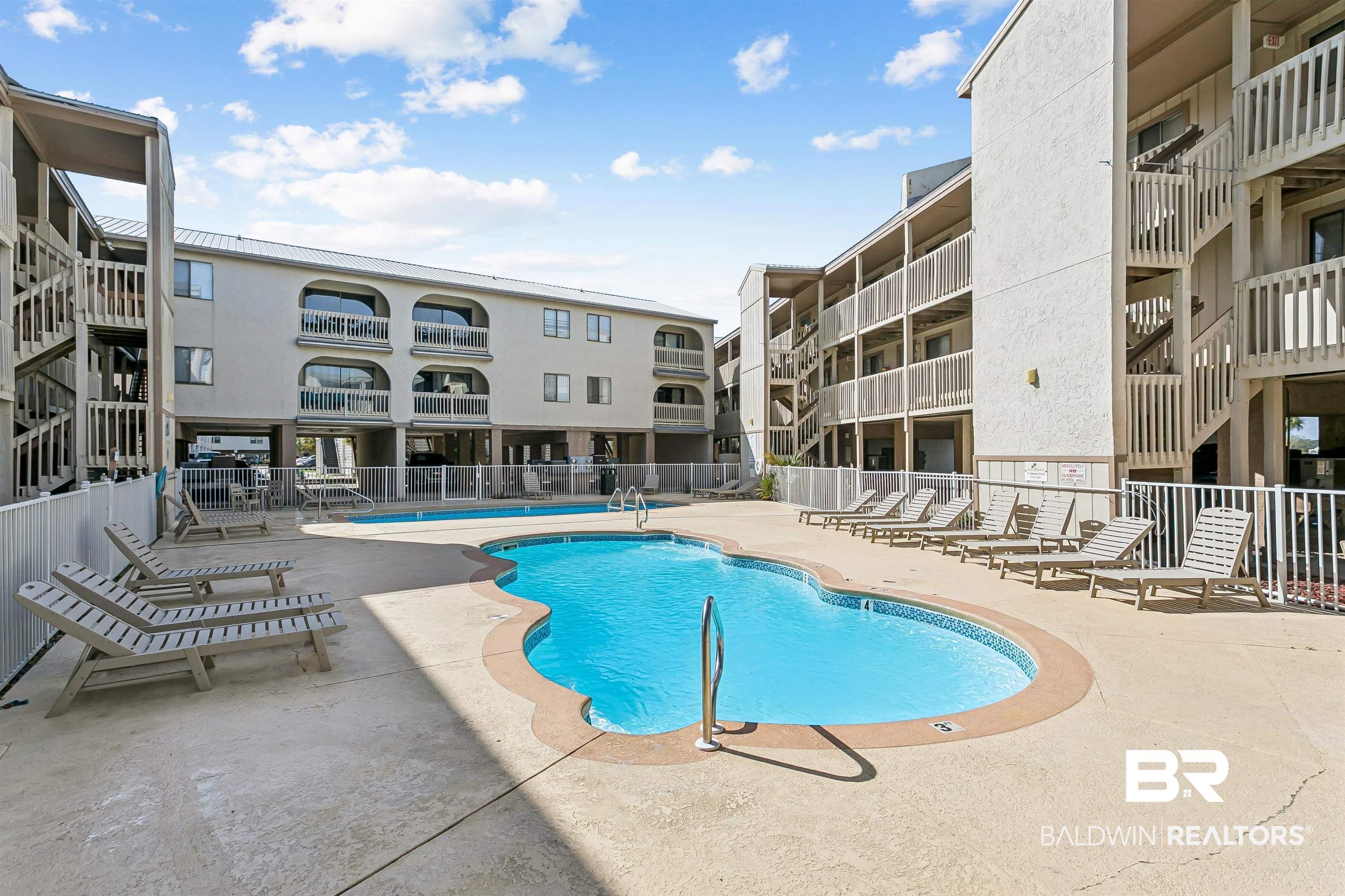 Image 4: Community pool with a patio