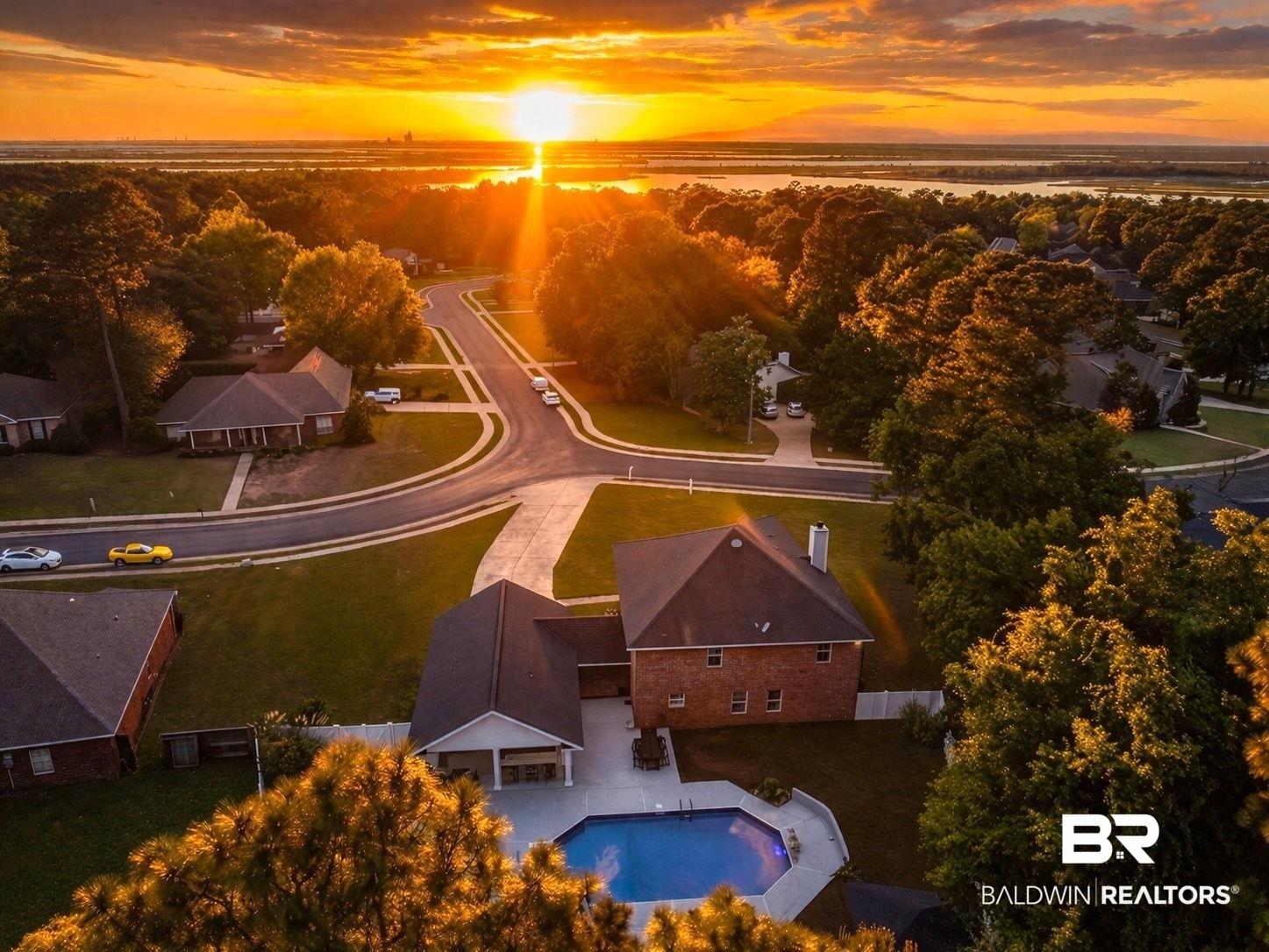 Image 3: Aerial view at dusk of view of pool