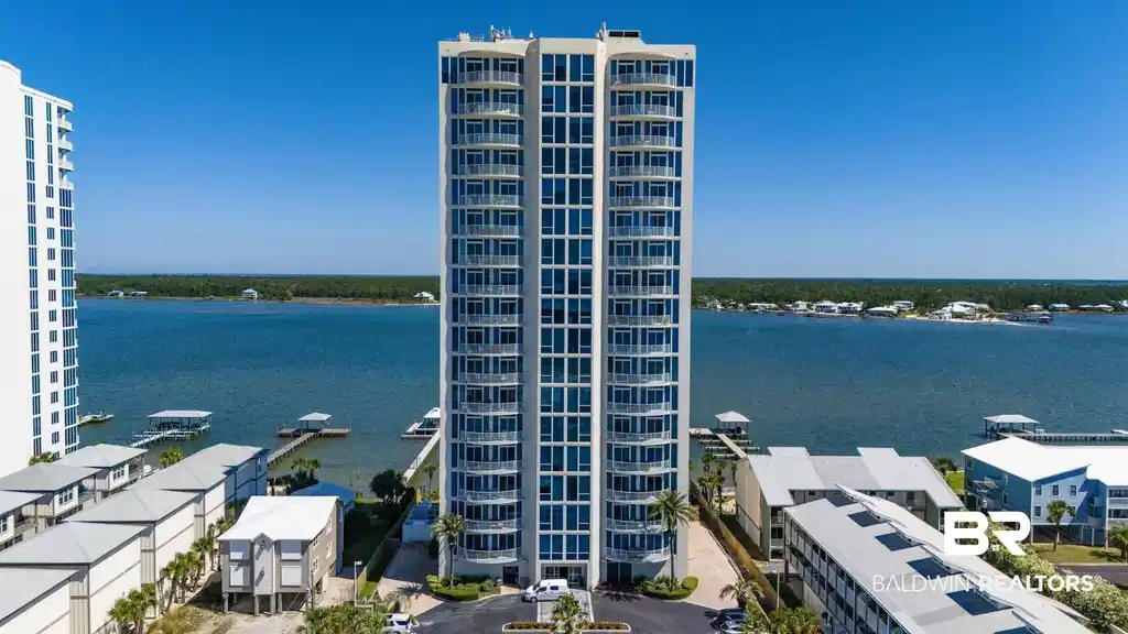 Image 1: Modern high-rise condominium building featuring numerous balconies and extensive window lines