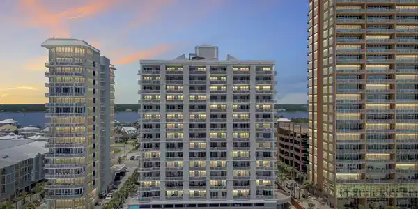 Image 2: Beachfront high-rise building featuring multiple private balconies with glass railings