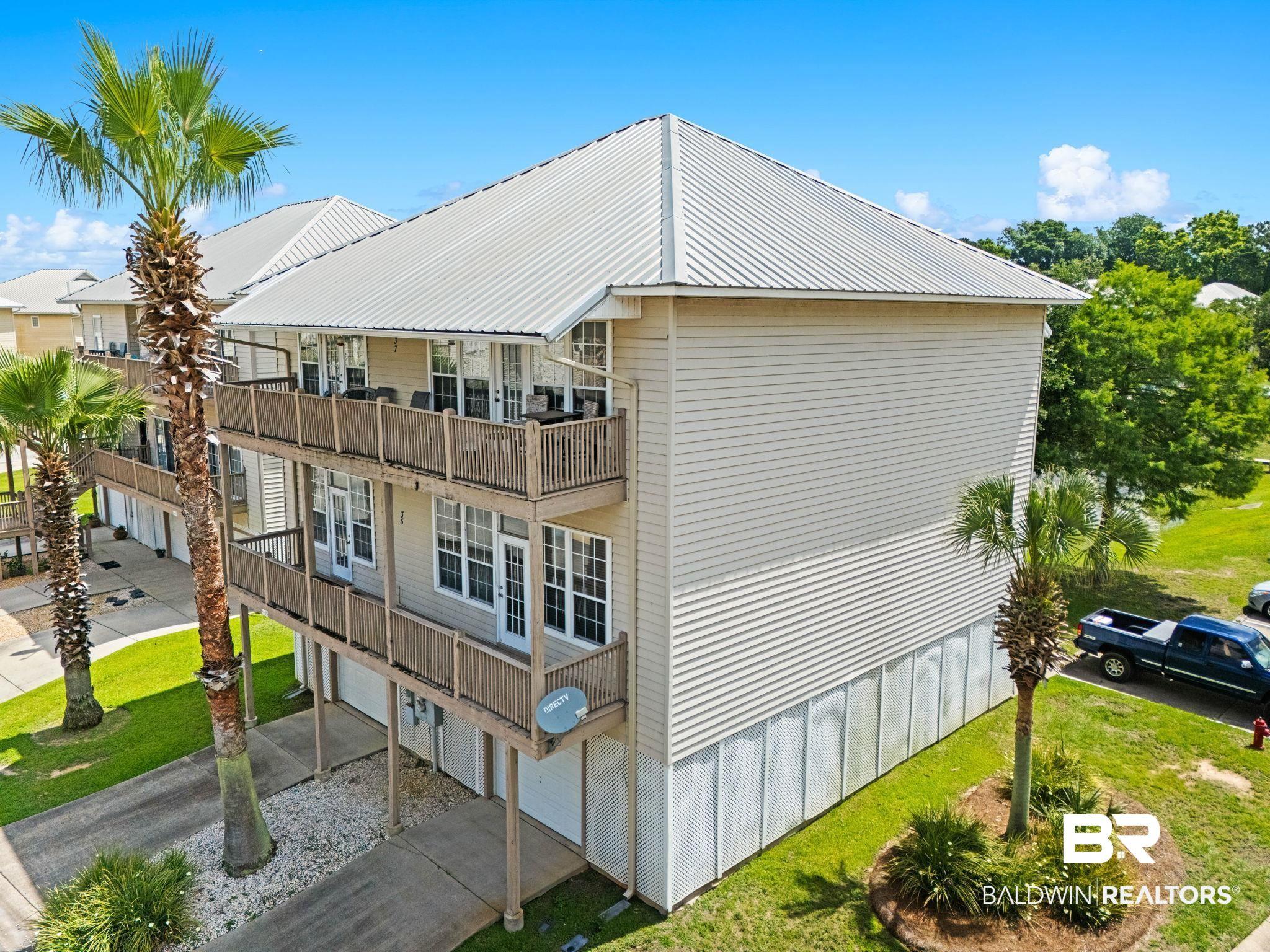 Image 2: Multi-level property featuring siding exterior and a metal roof
