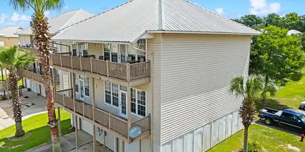 Image 2: Multi-level property featuring siding exterior and a metal roof