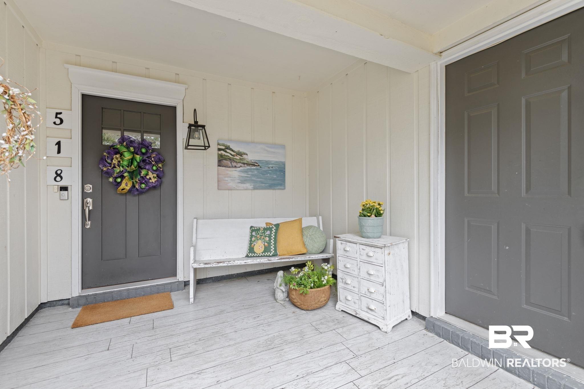Image 2: Entrance to property featuring board and batten siding