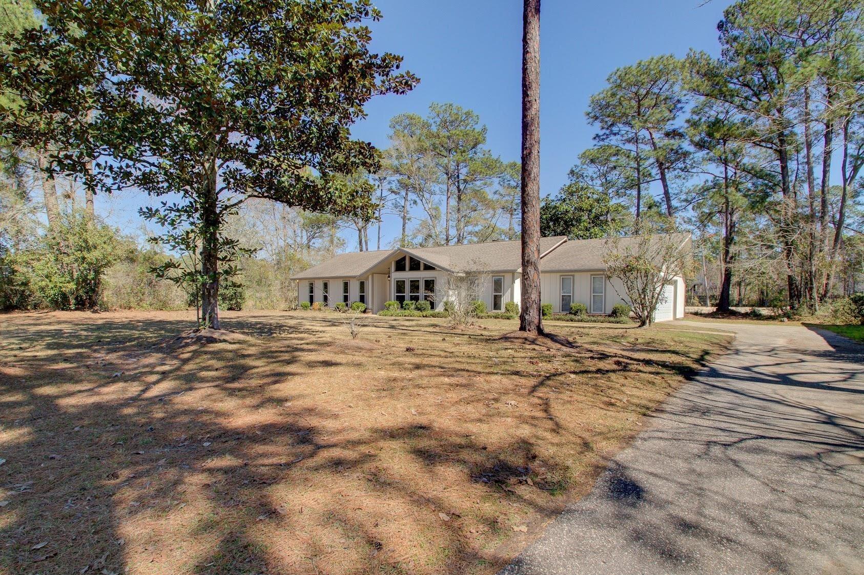 Image 2: View of front of home with driveway and a garage