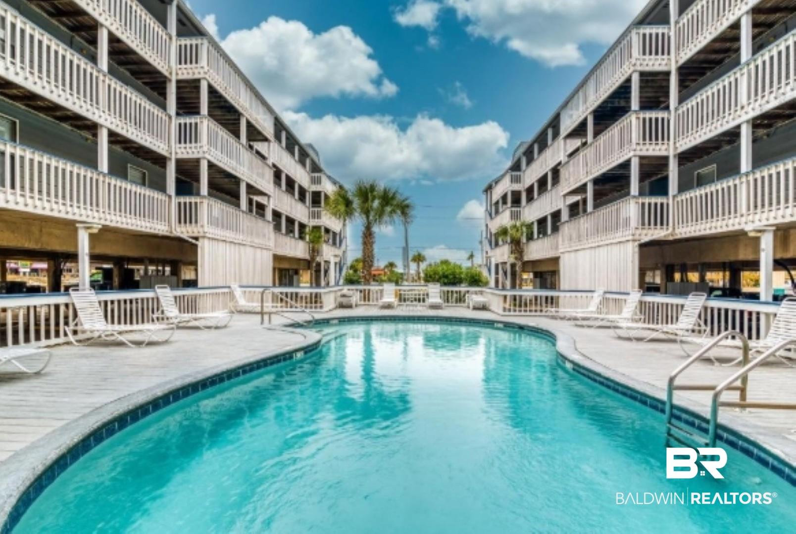 Image 1: Community pool featuring a patio area