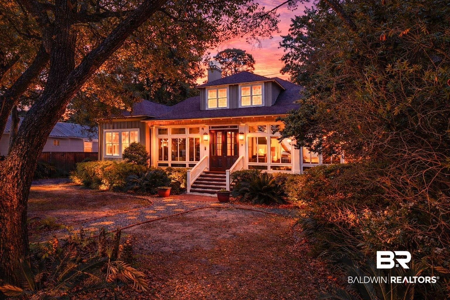 Image 3: View of front of property with a chimney, a porch, and french doors