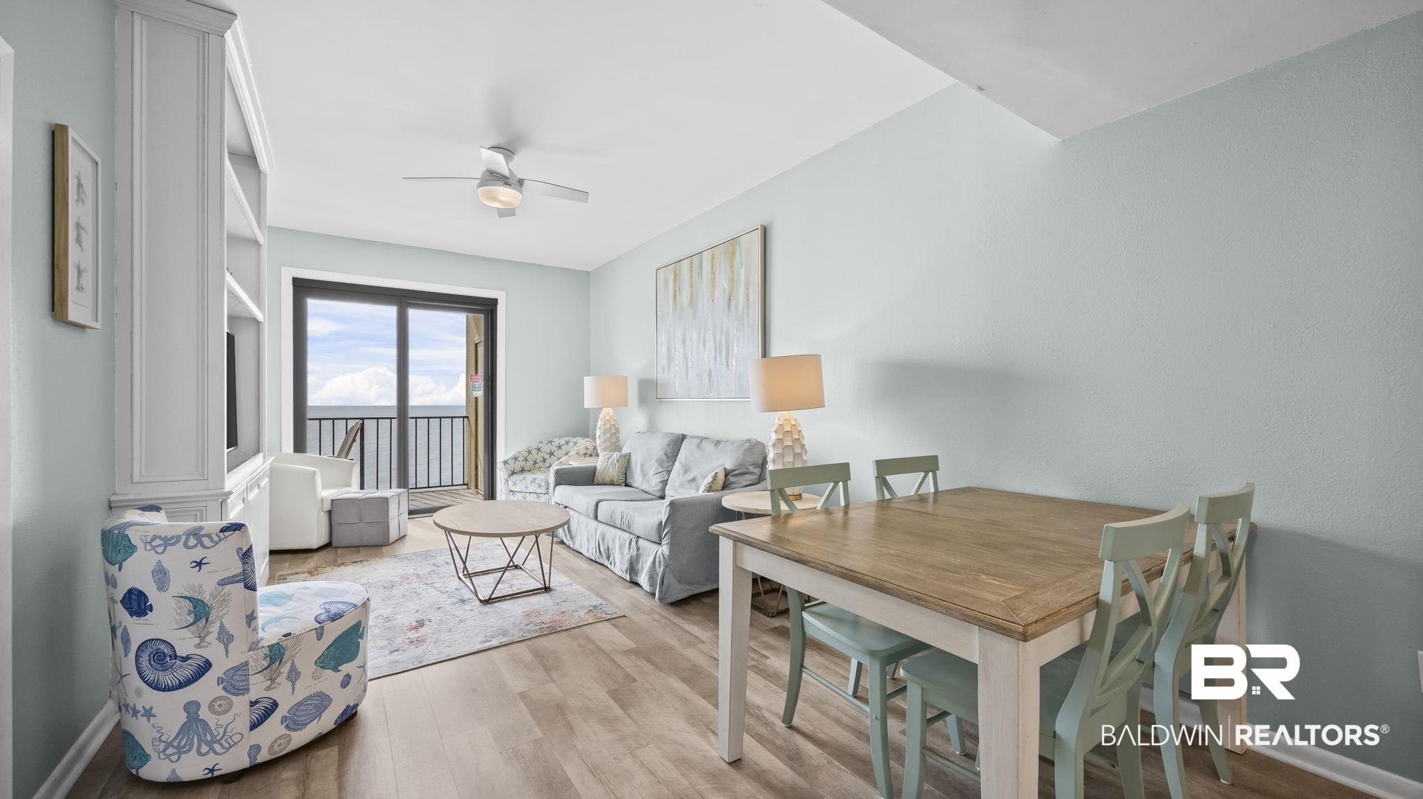 Image 4: Living area with wood finished floors and ceiling fan