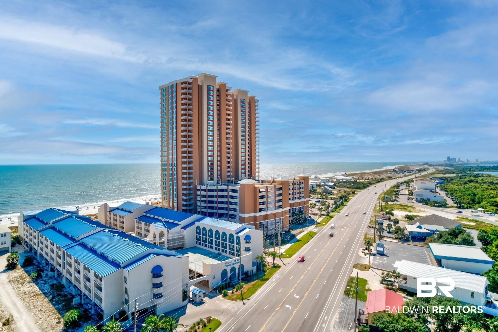 Image 4: View of urban area with expansive beach and apartment complex