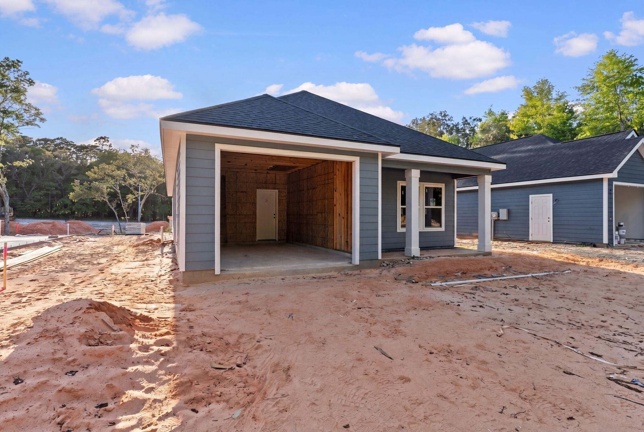 Image 3: View of front of house featuring a shingled roof and a patio