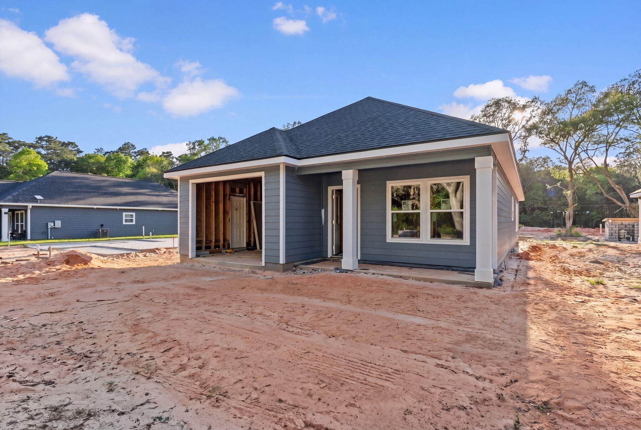 Image 4: Back of house featuring a patio and a shingled roof