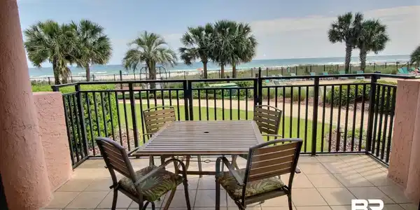 Image 3: Balcony overlooking pool and beach