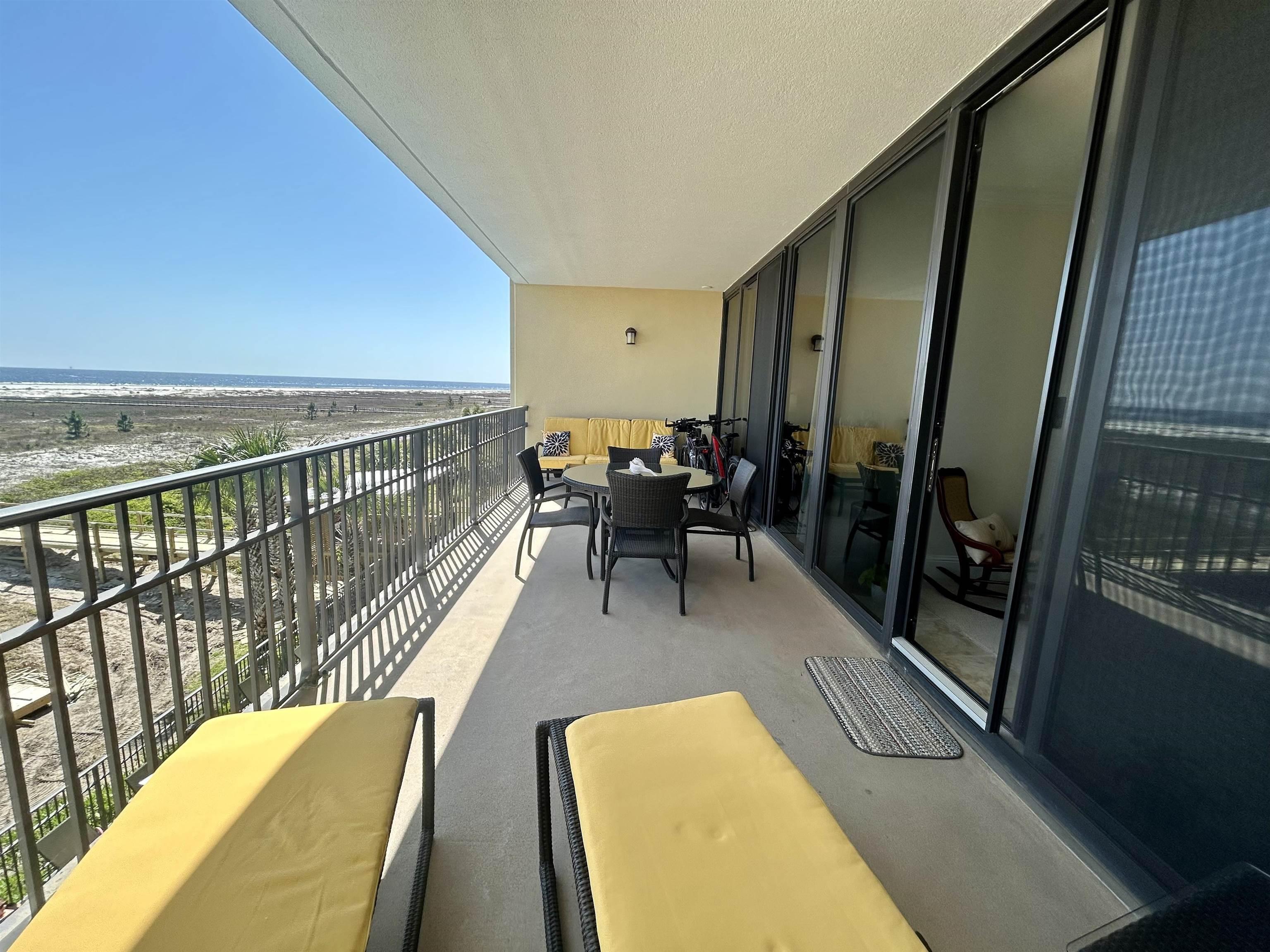 Image 4: Balcony featuring a beach view and a water view