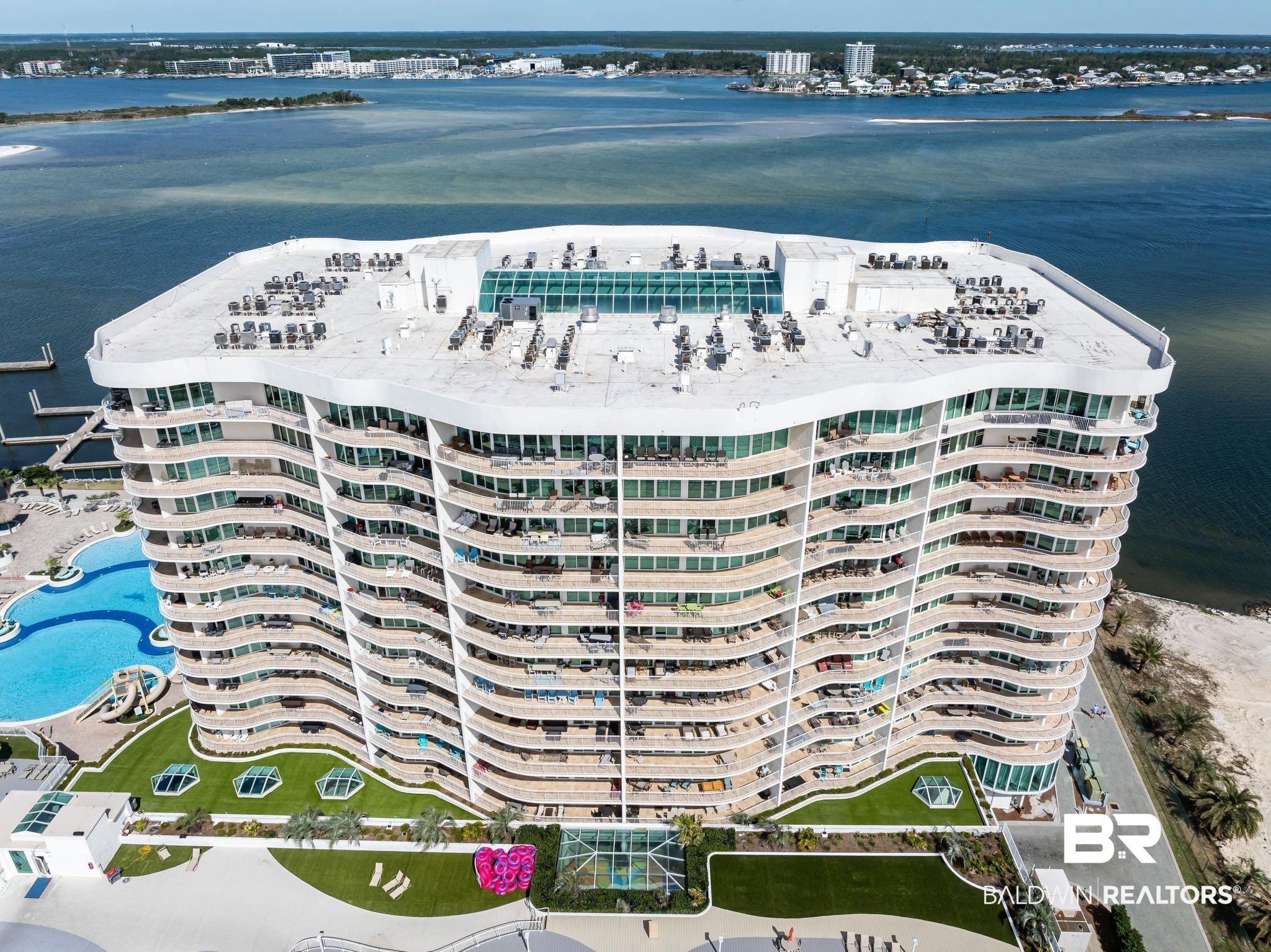 Image 1: Bird's eye view with a water view