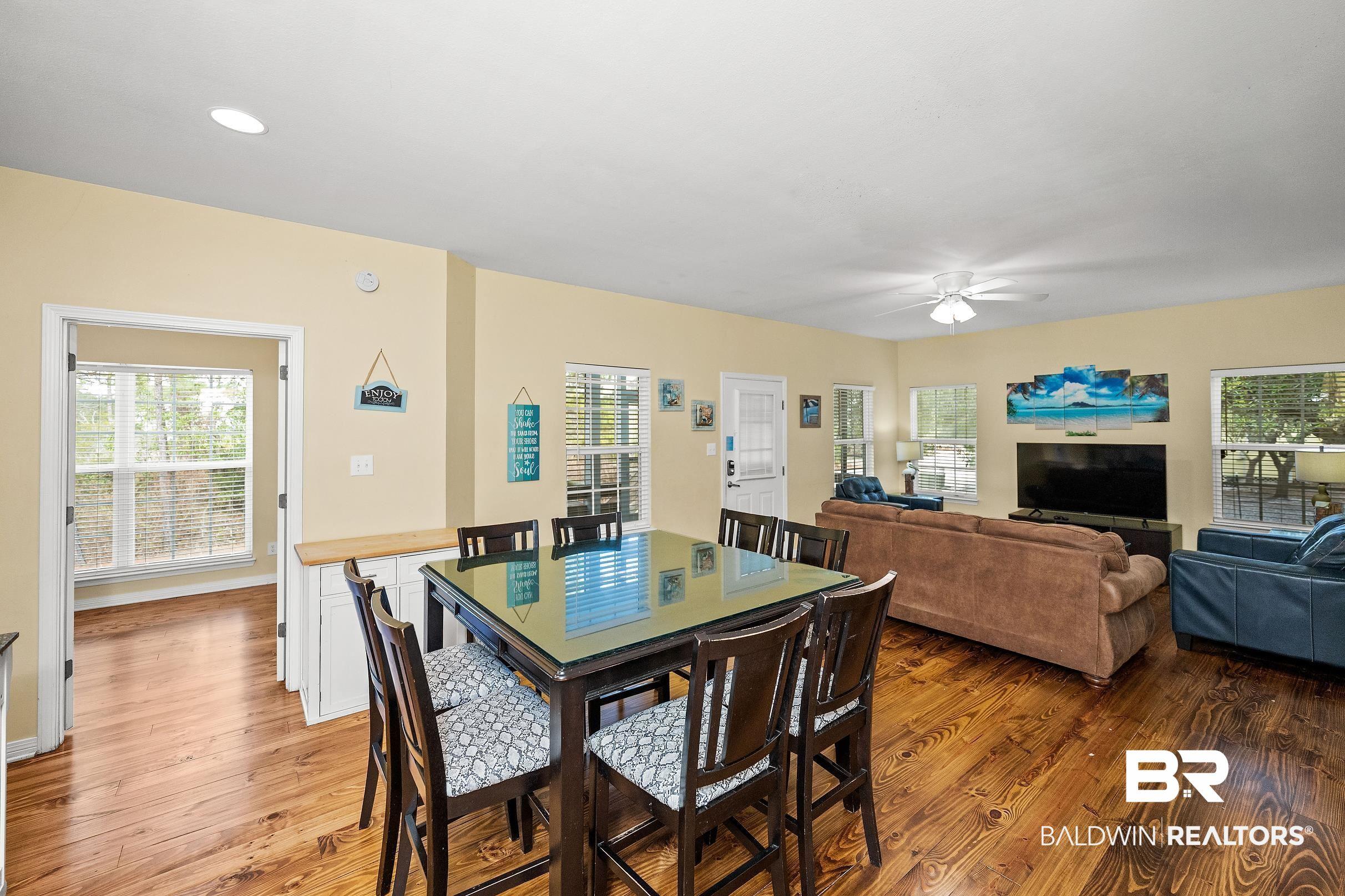 Image 4: Dining room with plenty of natural light, light wood-style floors, and a ceiling fan