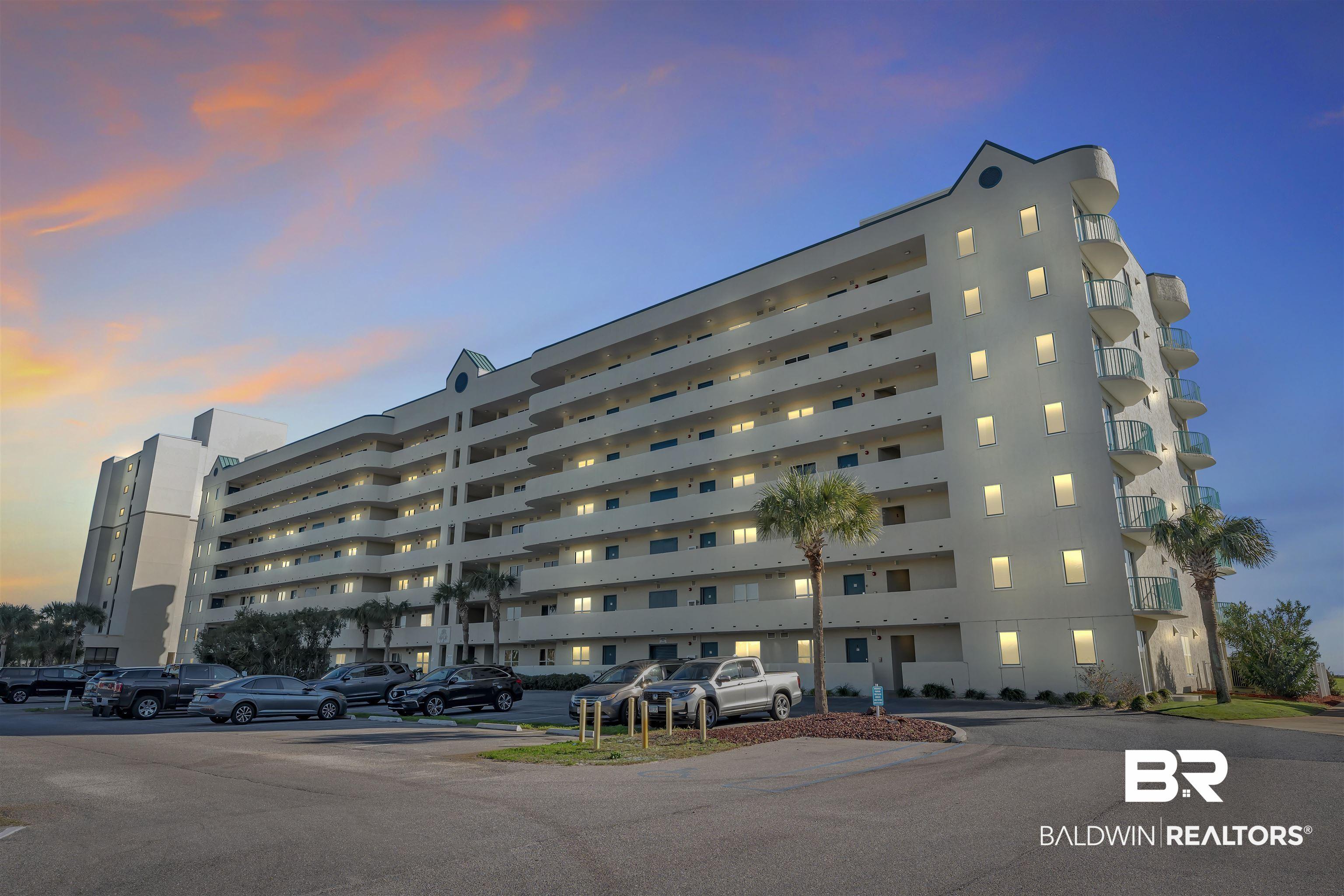 Image 2: Multi-story residential building featuring numerous private balconies with glass railings