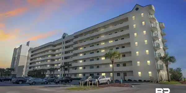 Image 2: Multi-story residential building featuring numerous private balconies with glass railings