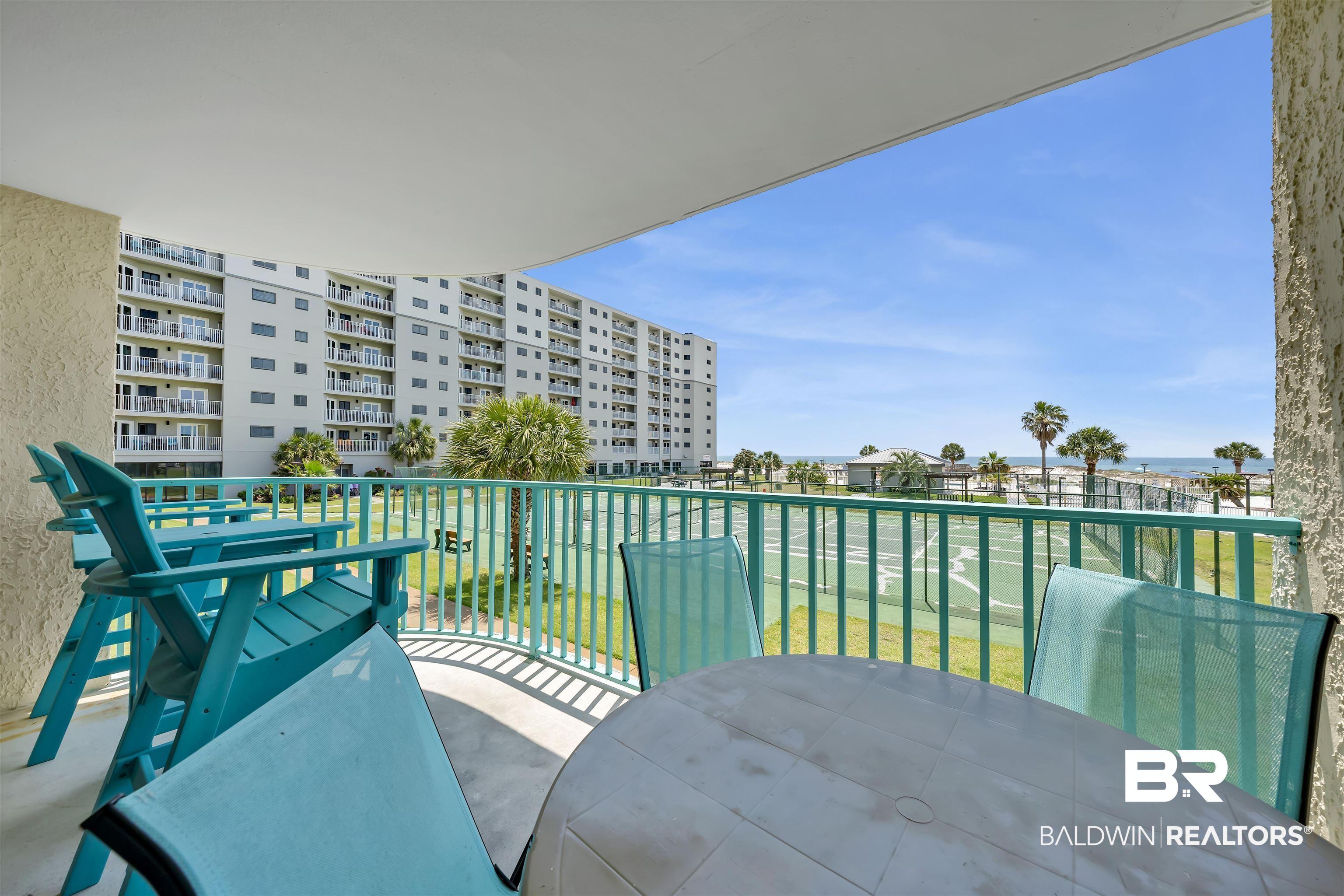 Image 4: Private balcony with a concrete floor and a teal railing