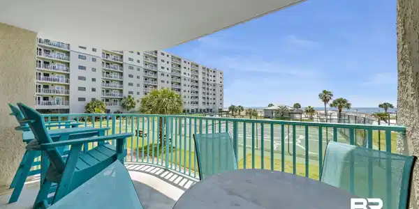Image 4: Private balcony with a concrete floor and a teal railing