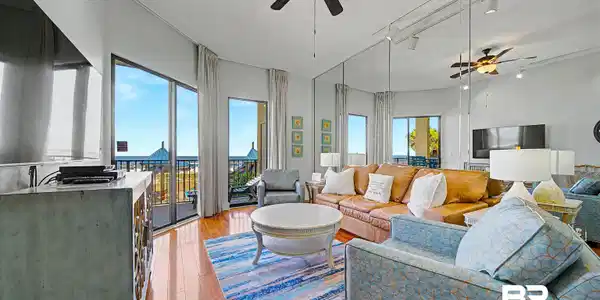 Image 3: Spacious living area featuring wood-finish flooring and direct balcony access