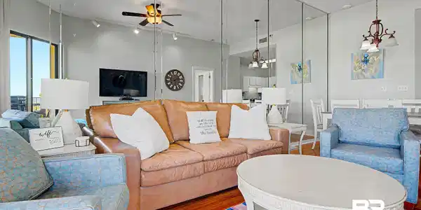 Image 4: Living area featuring wood-finish flooring and a full mirrored wall