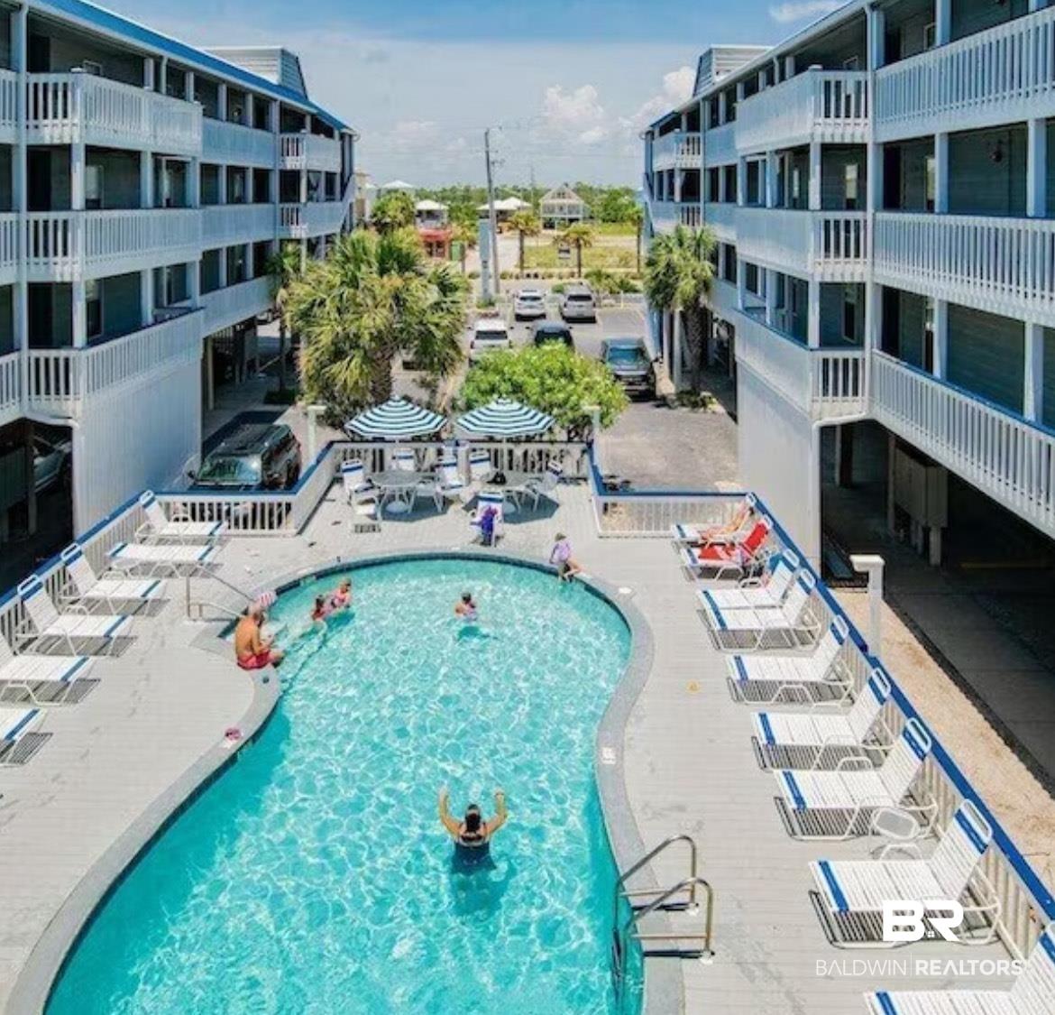 Image 2: Community pool featuring a patio area