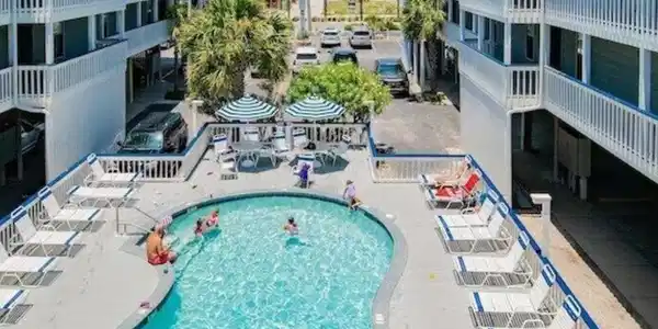 Image 2: Community pool featuring a patio area