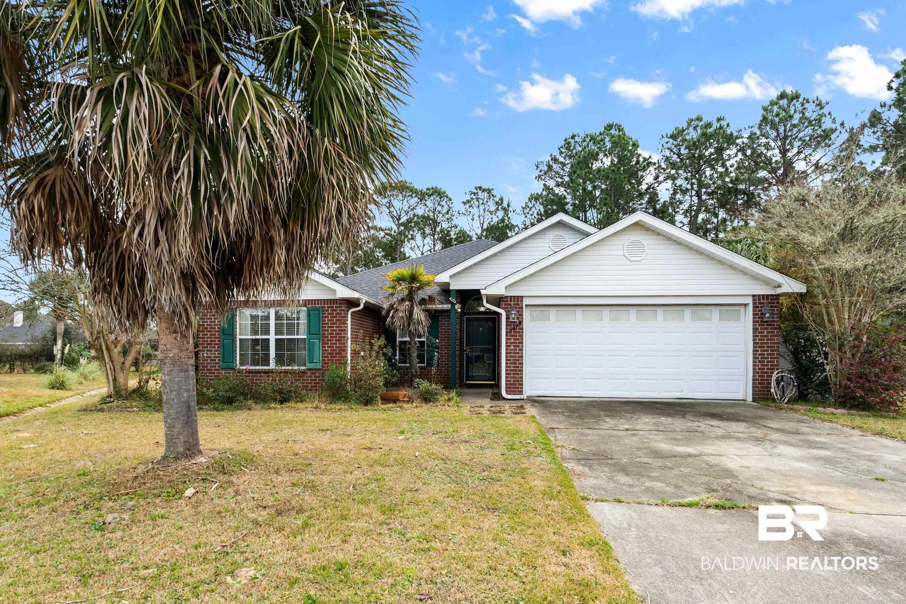 Image 1: Ranch-style house featuring a front yard, brick siding, concrete driveway, and a garage