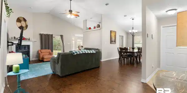 Image 3: Living area featuring wood finished floors, high vaulted ceiling, and a ceiling fan