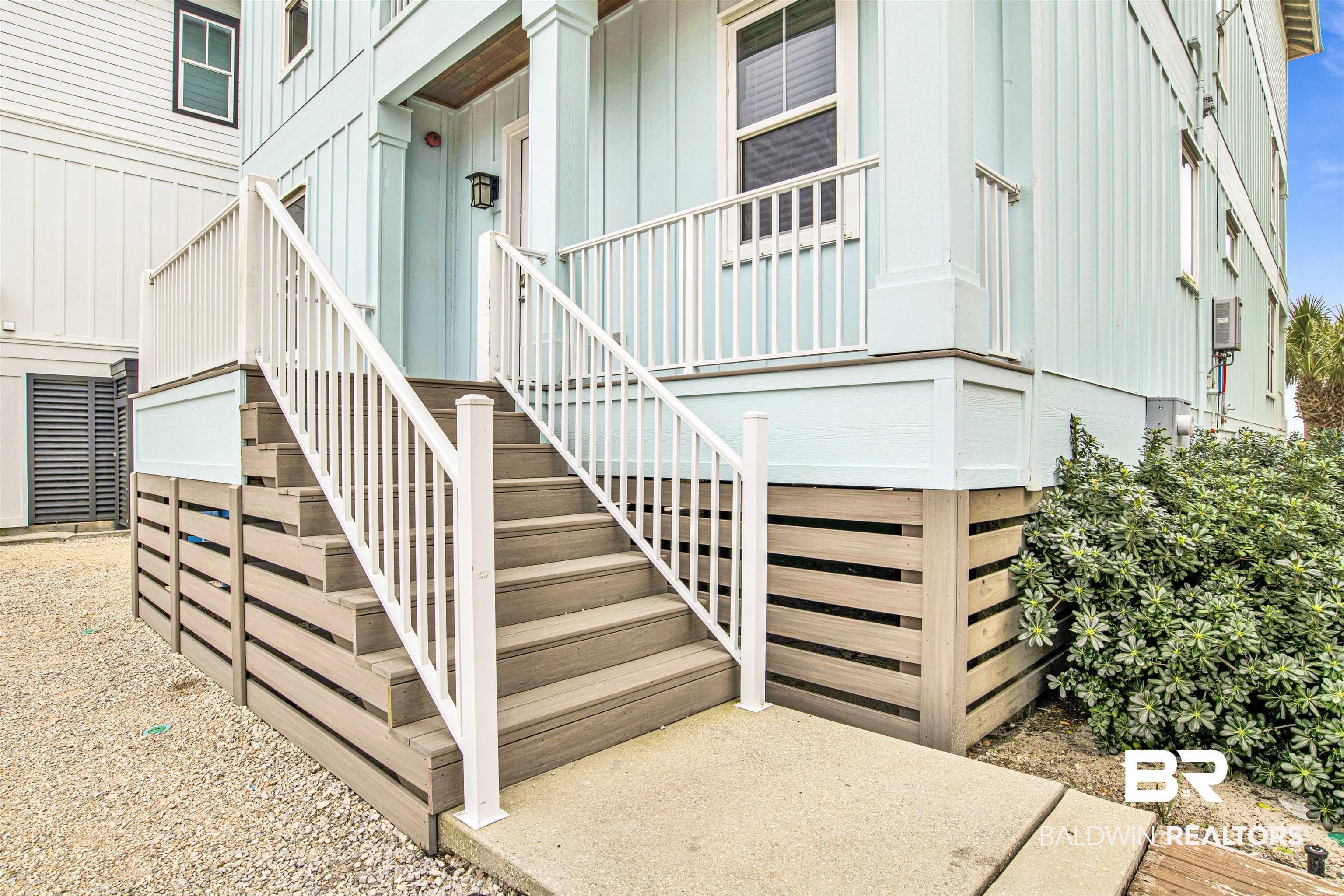 Image 2: Doorway to property with board and batten siding