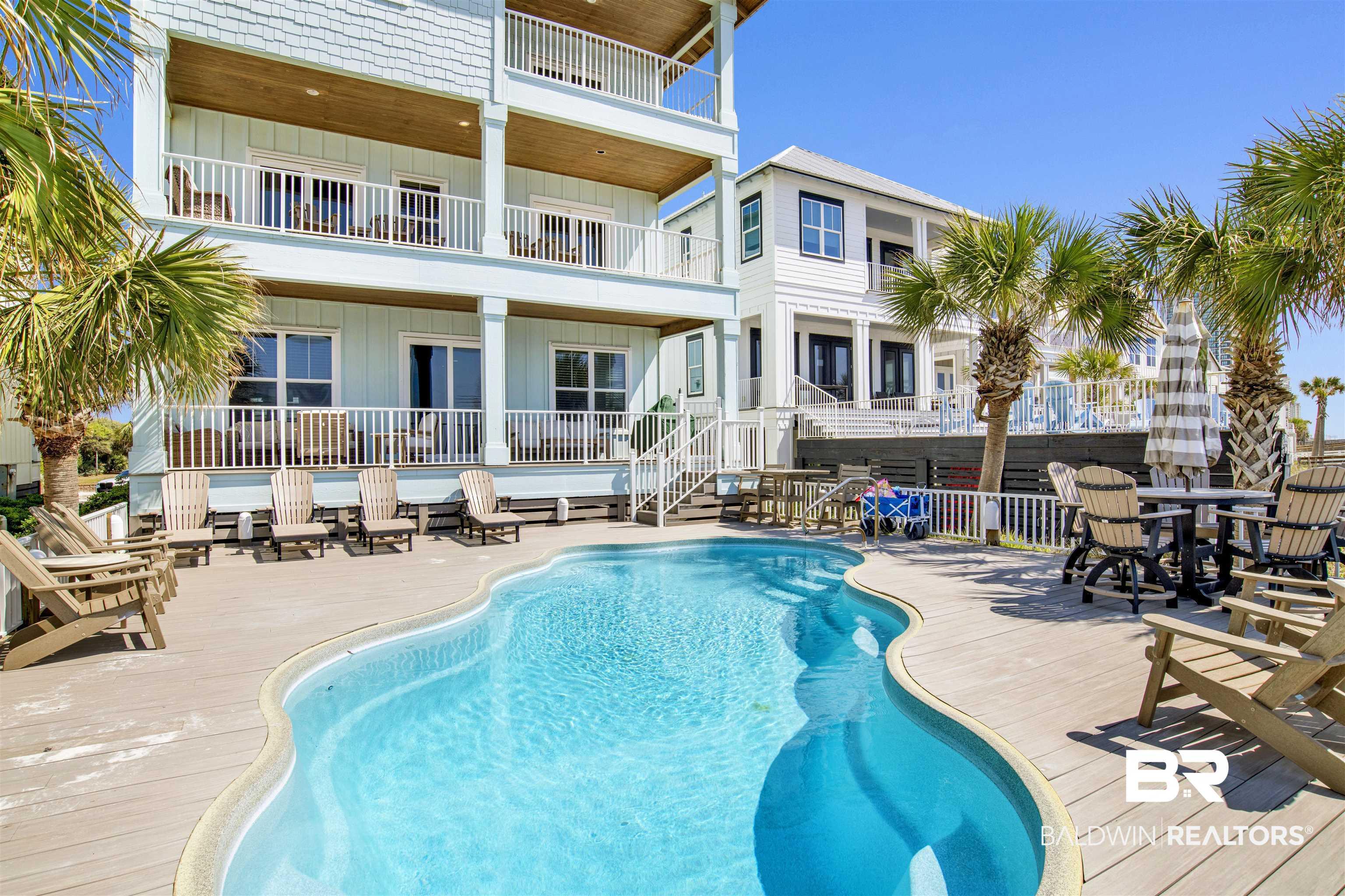 Image 4: View of pool with a wooden deck, a fenced in pool, and fence
